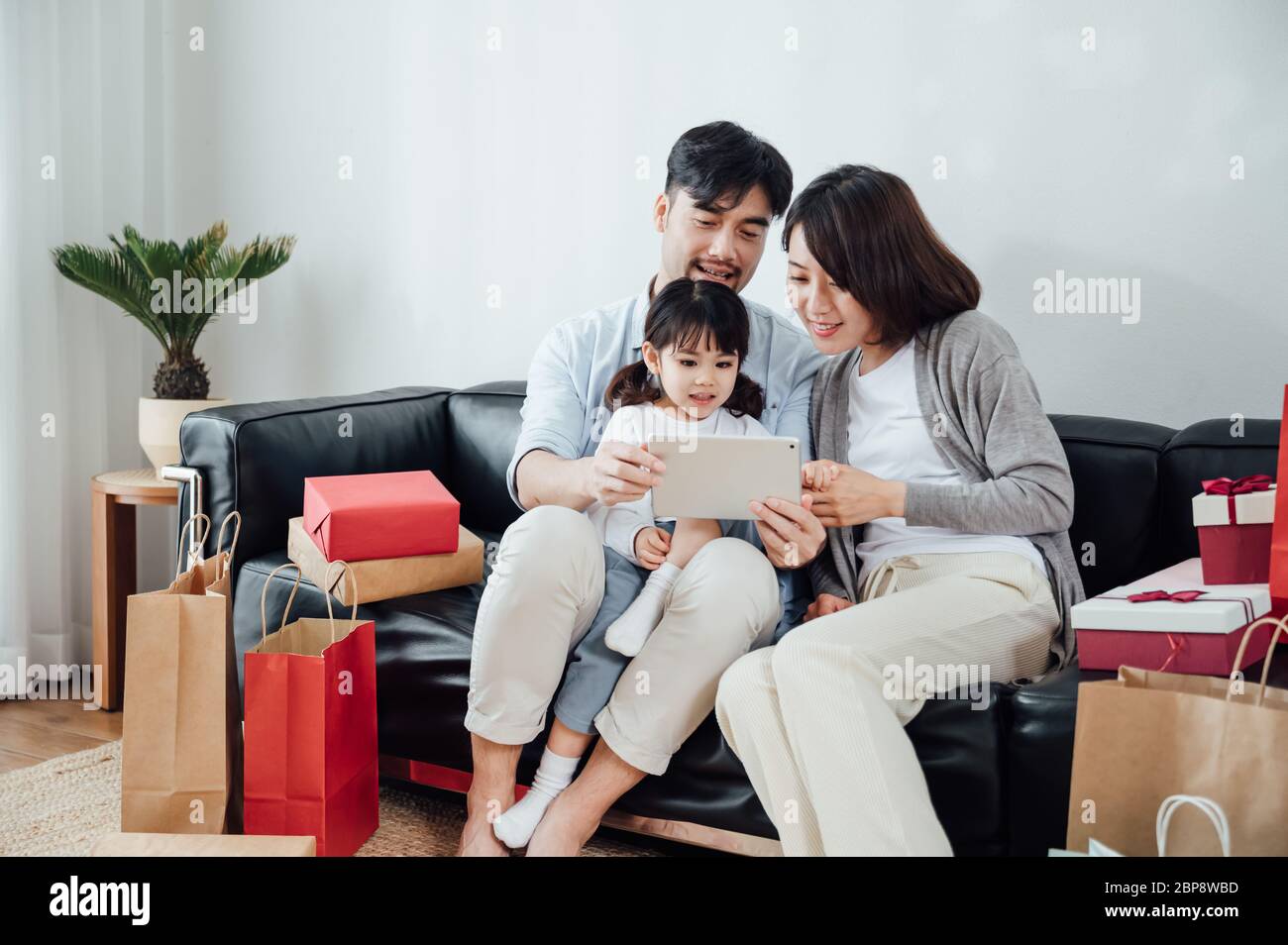 Mom and Dad and daughter at home using a Tablet PC Stock Photo - Alamy