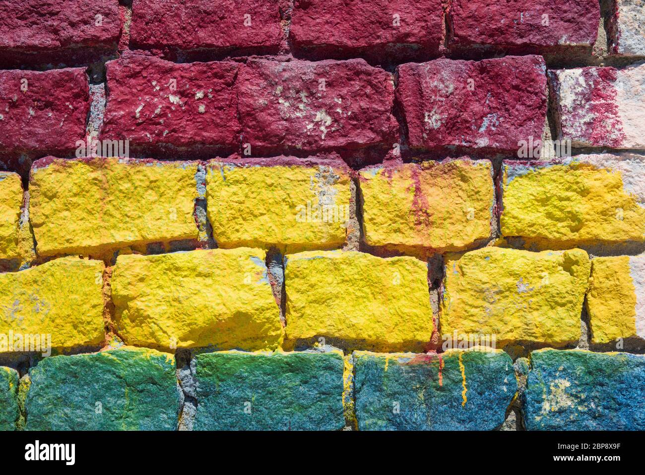 Detail of colored brickwall in red, yellow and blue. Stock Photo