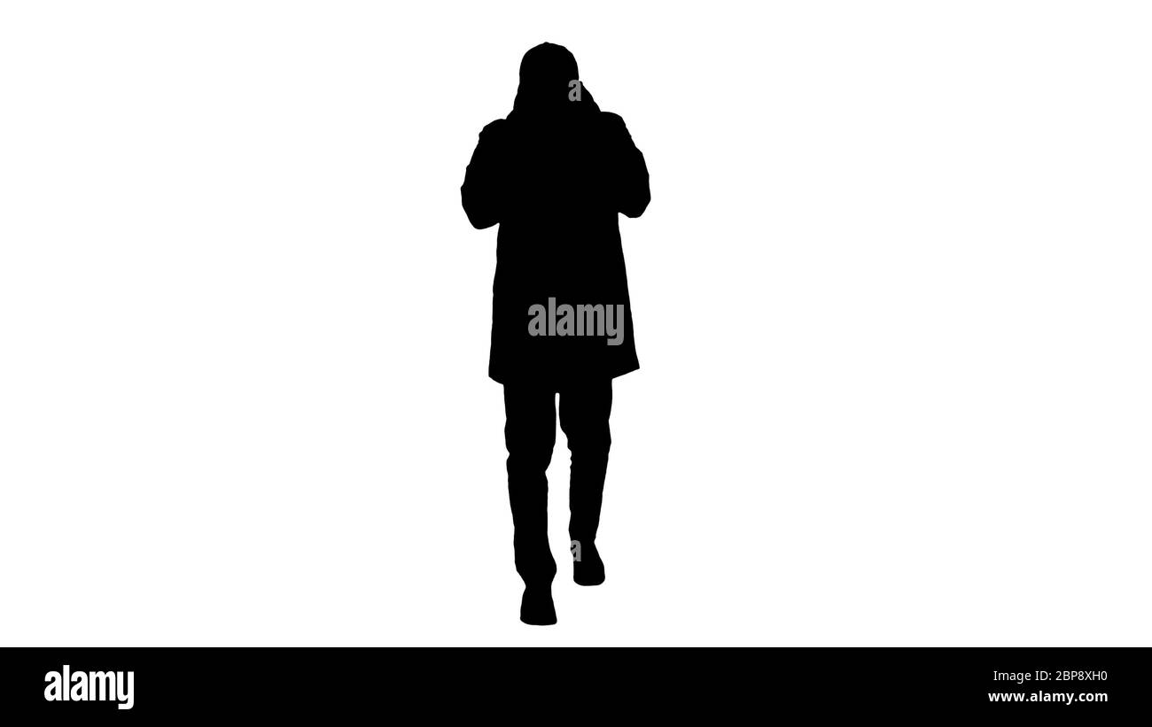 Silhouette Man in winter outfit walking and coughing. Stock Photo