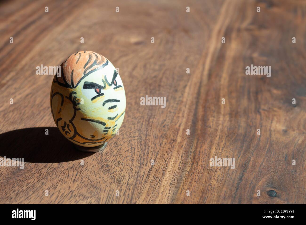 Colorful strong muscular bodybuilder Easter egg in wooden background