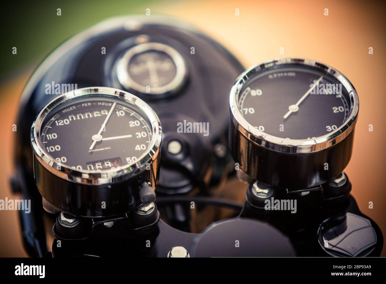 Close up horizontal image of the speedometer and tachometer gauges of a