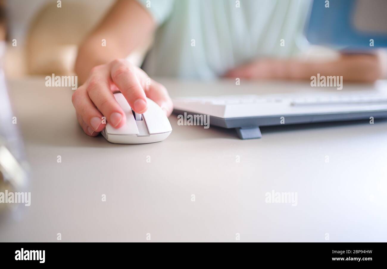 the developer works at computer, uses the mouse Stock Photo Alamy