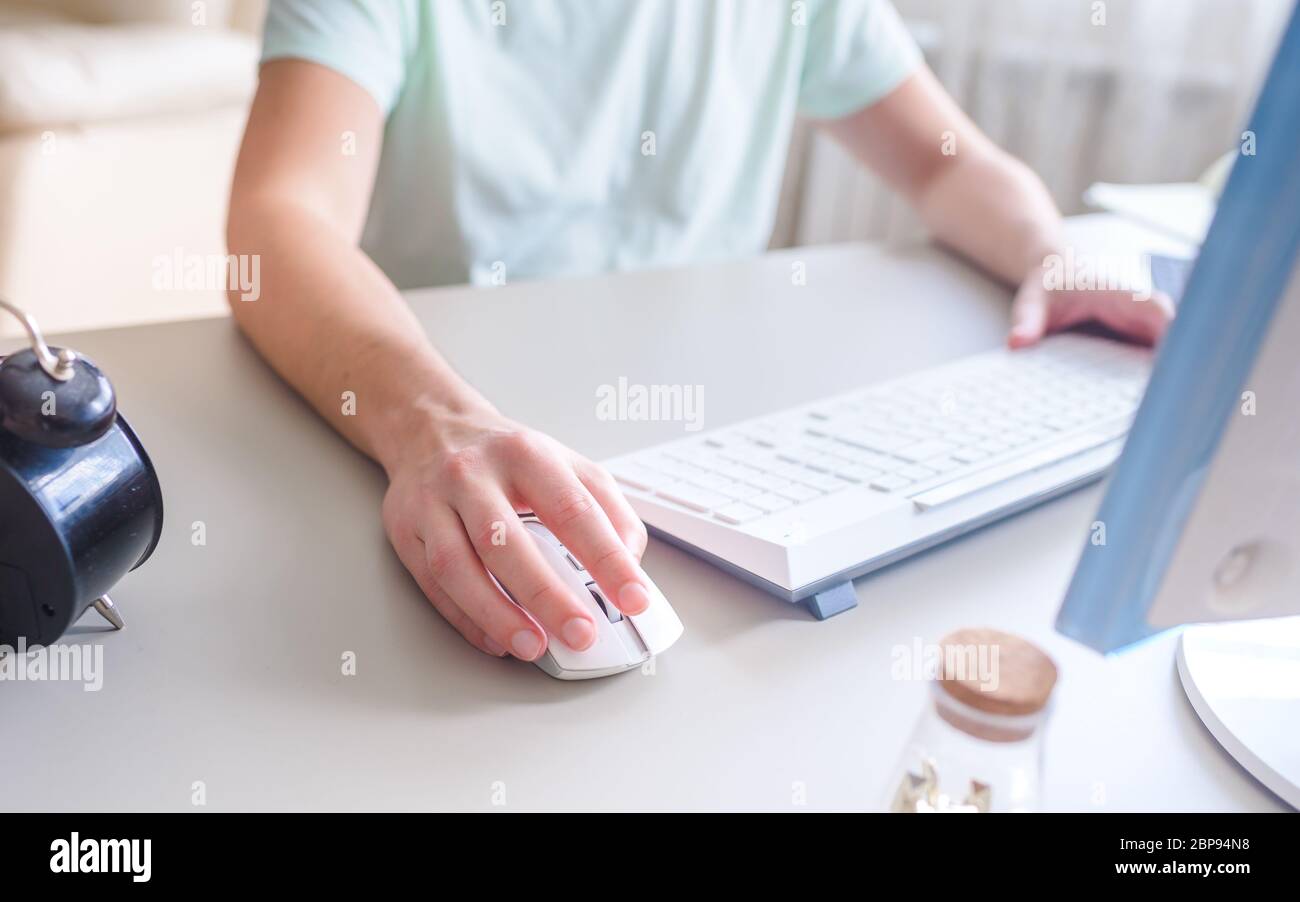 the developer works at the computer, uses mouse Stock Photo Alamy
