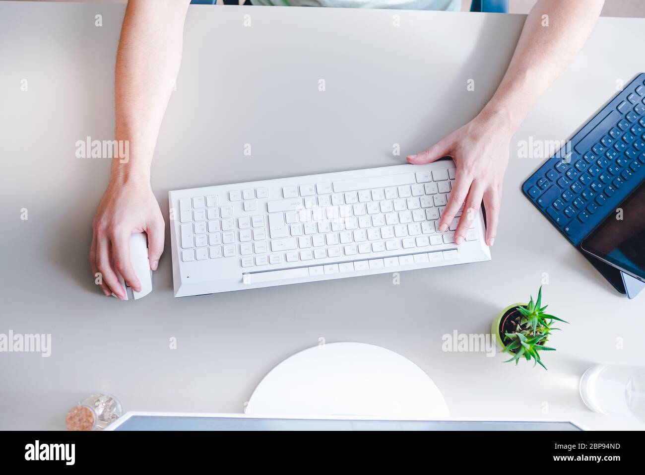 the developer works at computer, uses the mouse Stock Photo