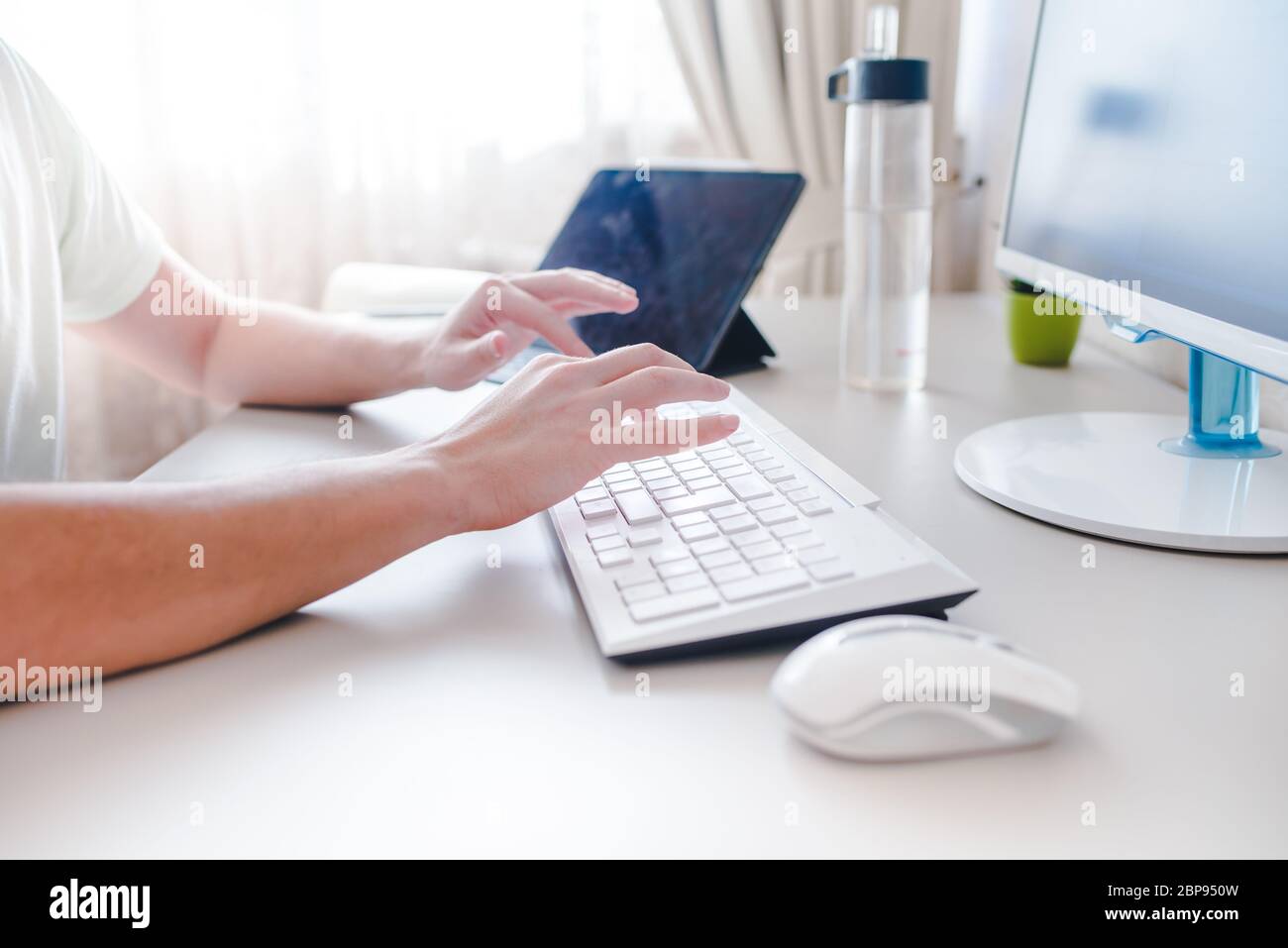 the developer works at computer, uses the mouse Stock Photo