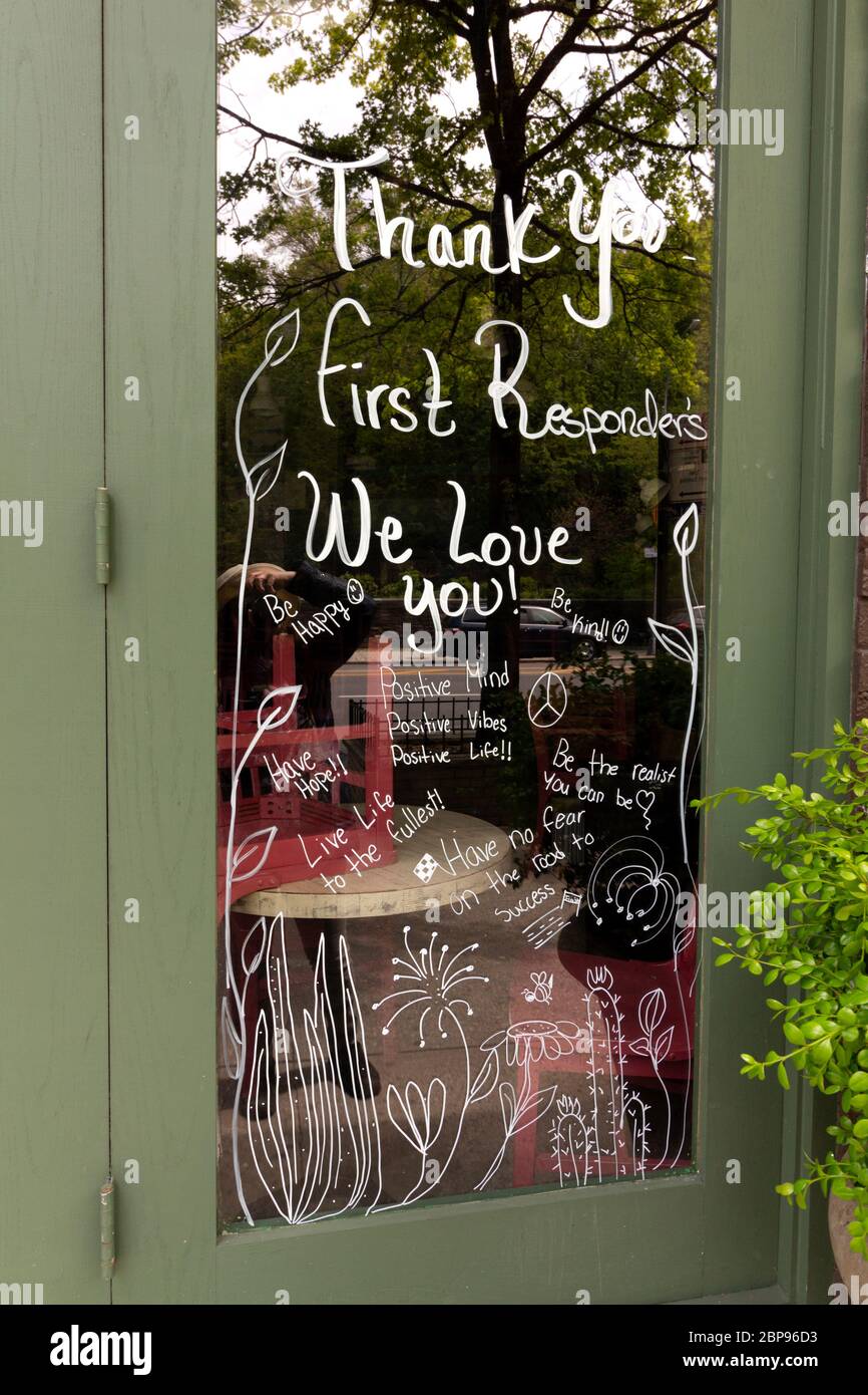 a cafe in upper manhattan decorated its window with a thank you to first responders and a floral design during the coronavirus or covid-19 pandemic Stock Photo
