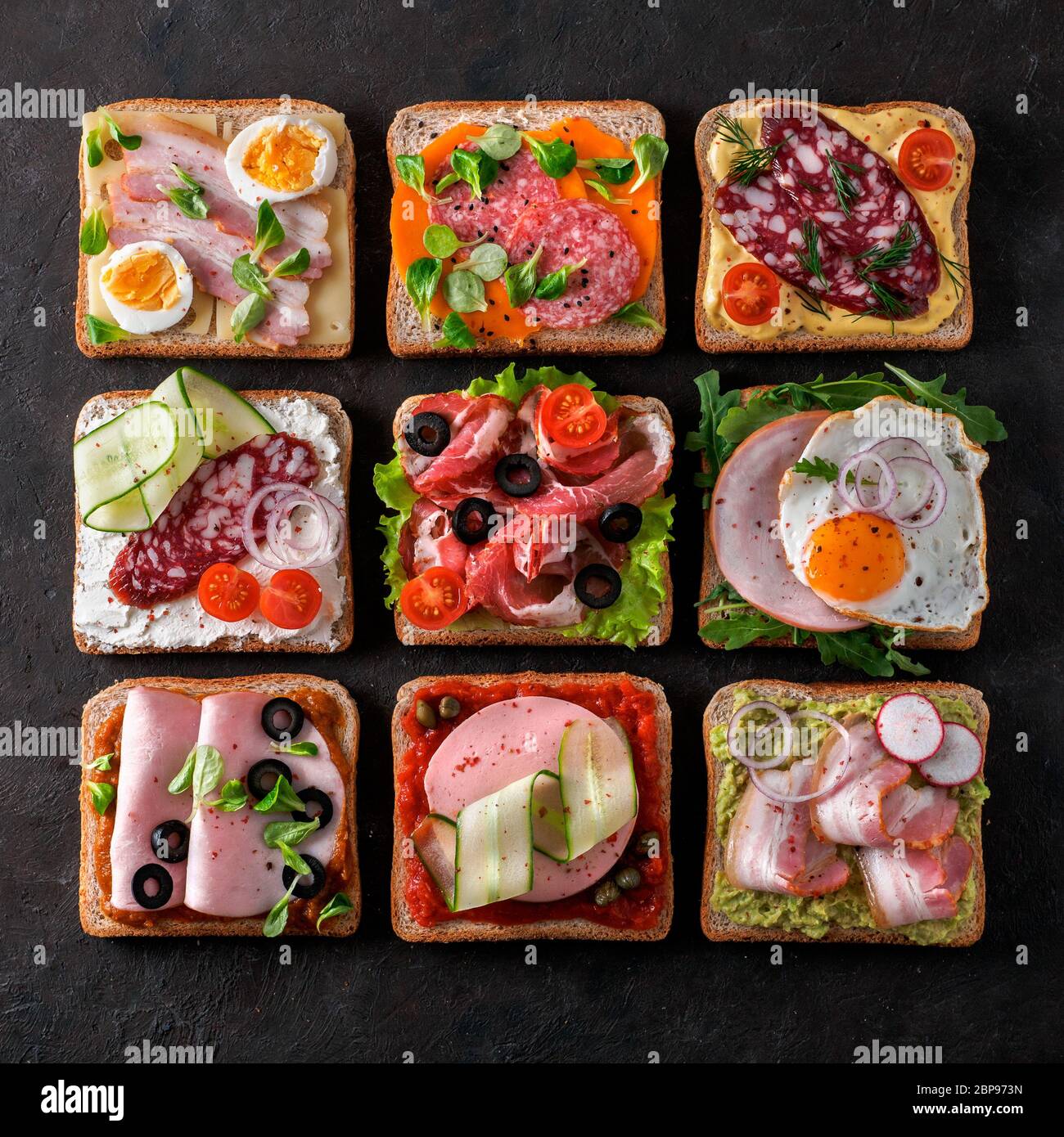Set of eight different sandwiches with meat in square shape. Top view or flat lay. Assortment meat toasts on black background. Idea, creative concept Stock Photo