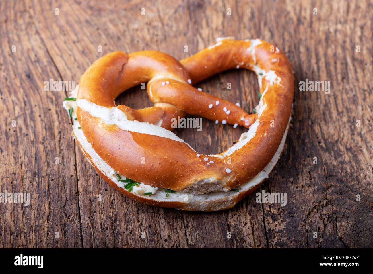 bavarian pretzel with butter on wood Stock Photo