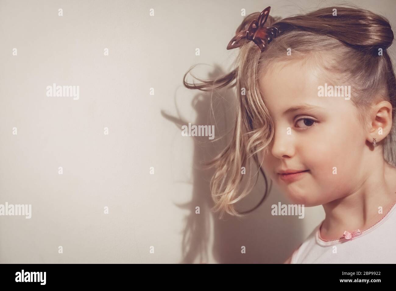 Portrait of a cute young Caucasian little girl with tied hair Stock Photo
