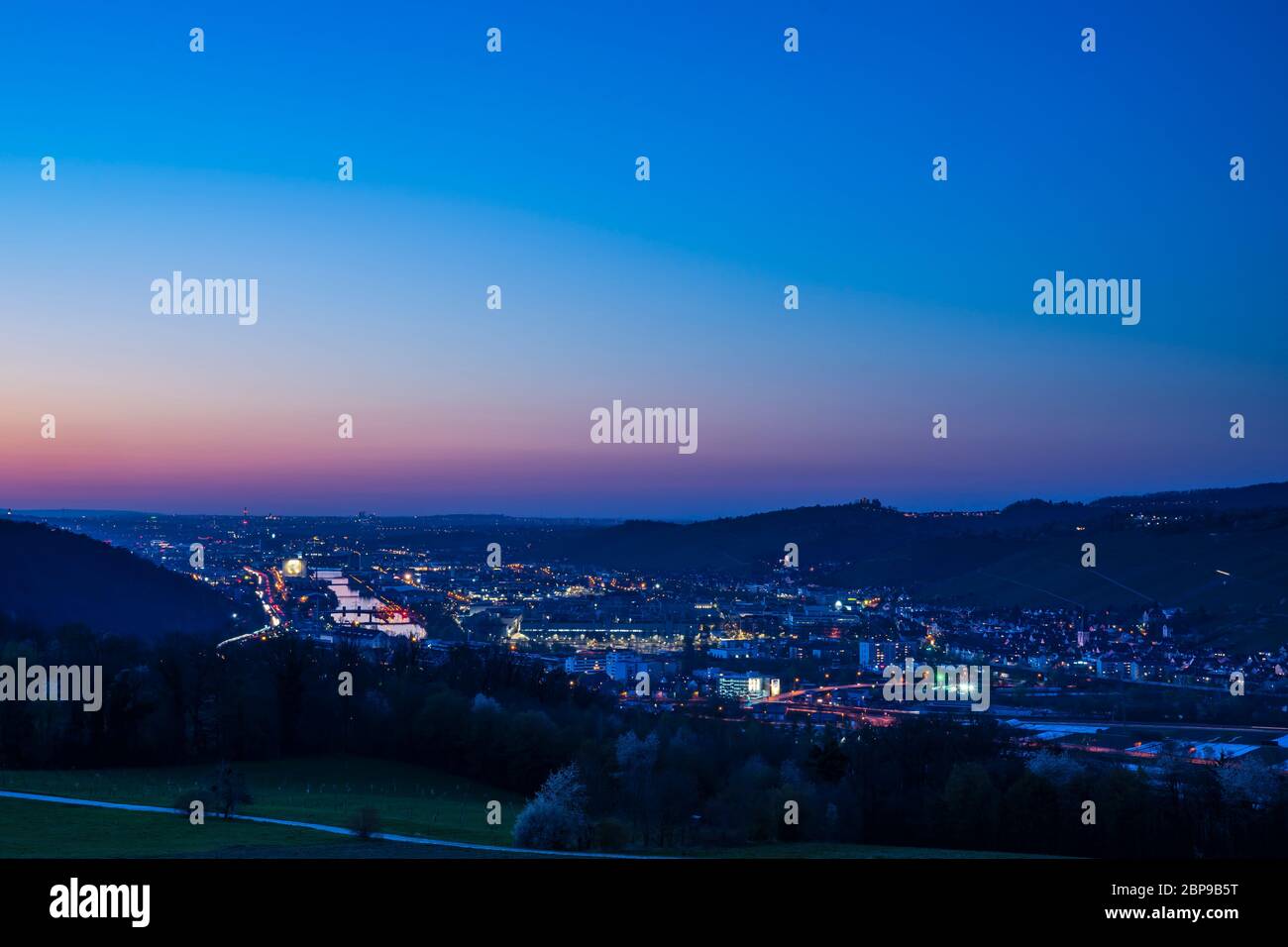 Germany, Day to night sunset and dawning over skyline of houses ...