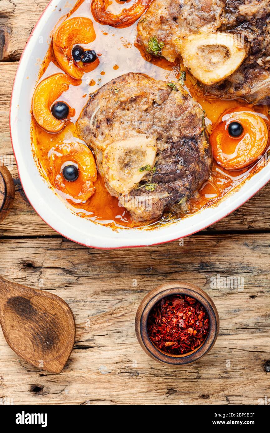 Ossobuco,traditional dish of Italian cuisine.Prepared osso buco veal.Meat stew with apricot