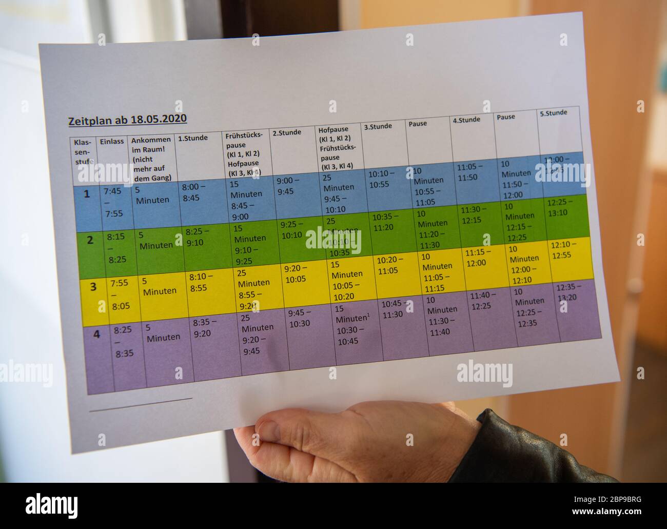 Dresden, Germany. 18th May, 2020. A primary school teacher holds a