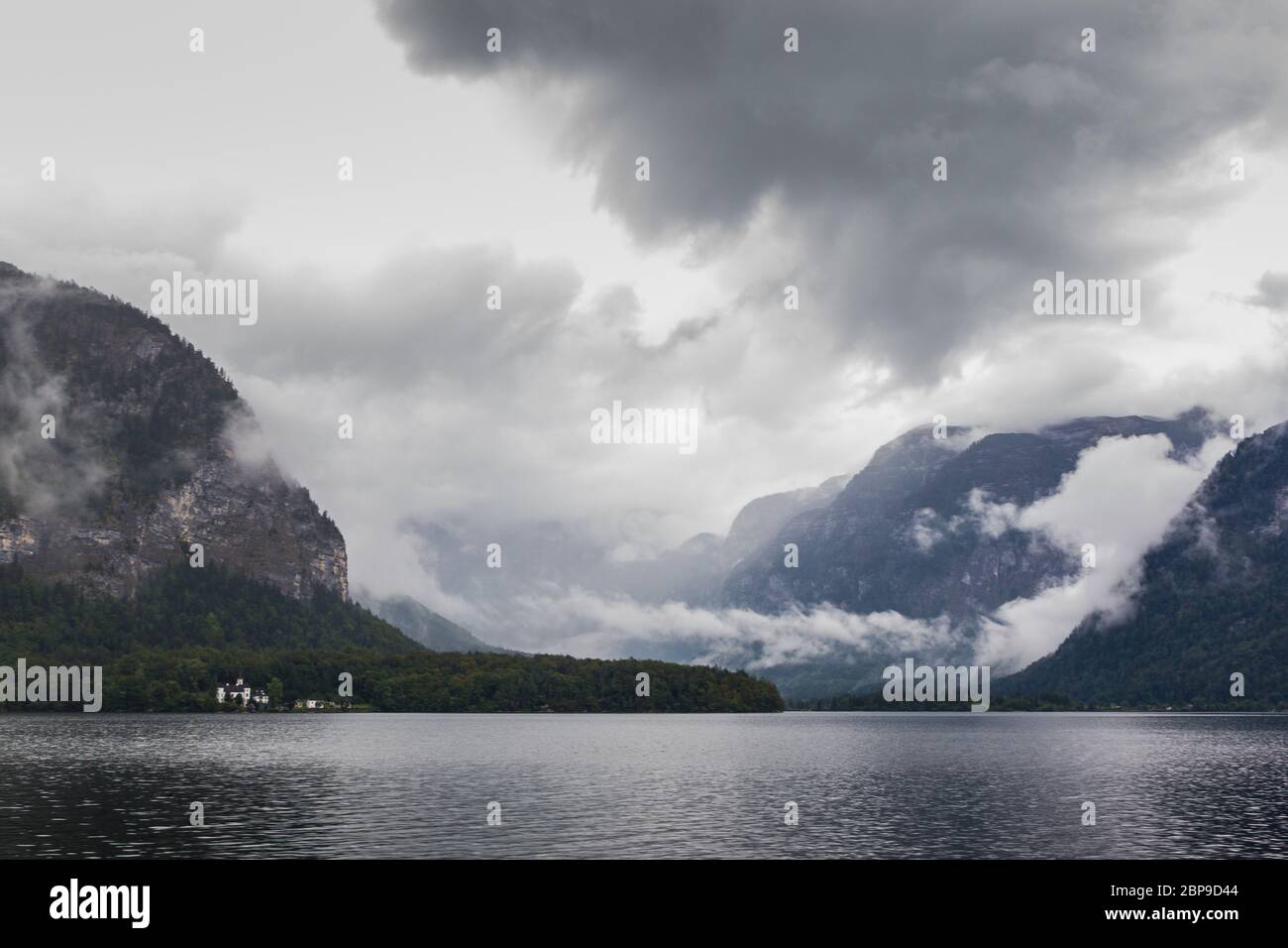 Hallstatt lake in a foggy day and clouds between the mountains Stock Photo