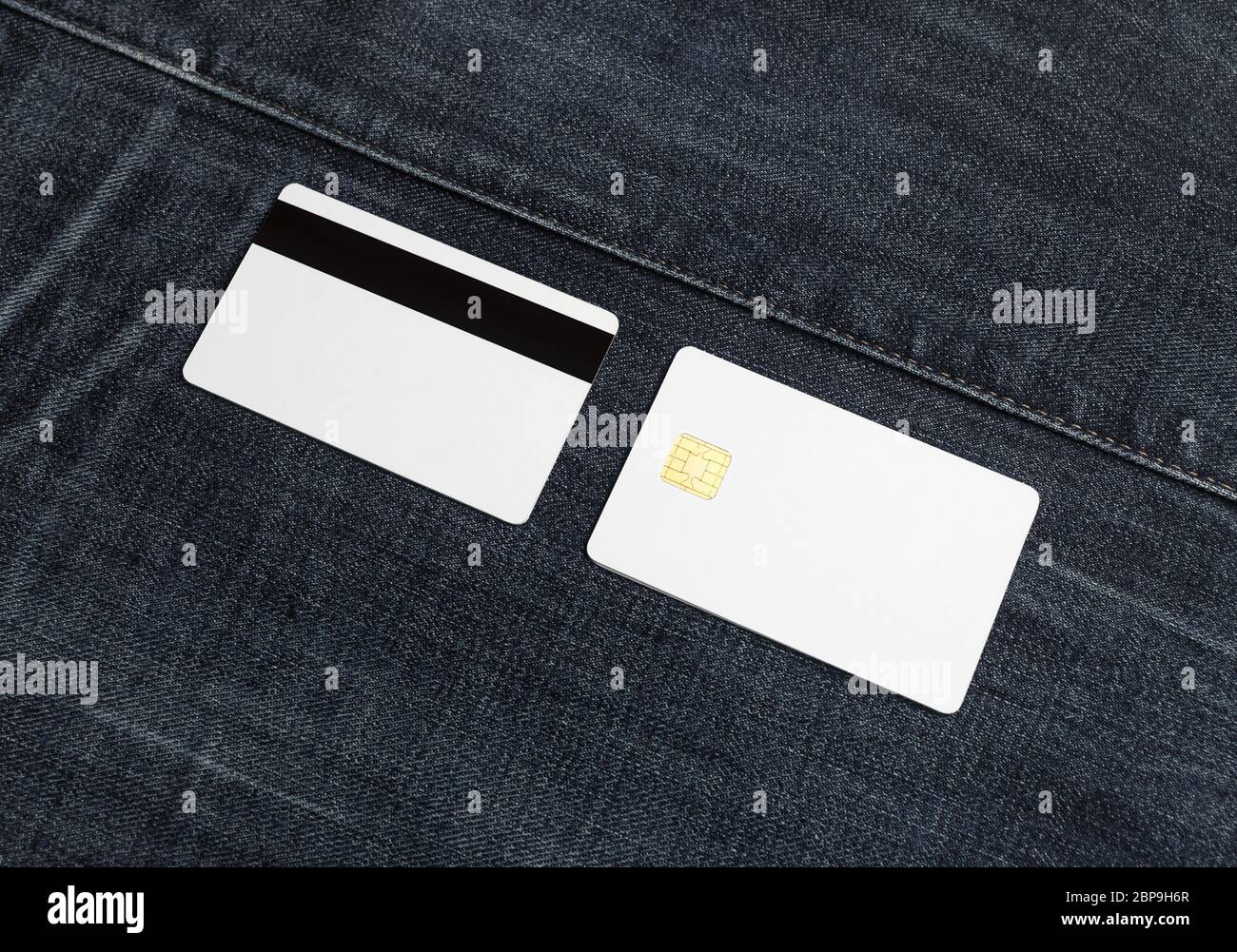 Blank bank cards on denim background. Credit cards. Front and back view. Stock Photo