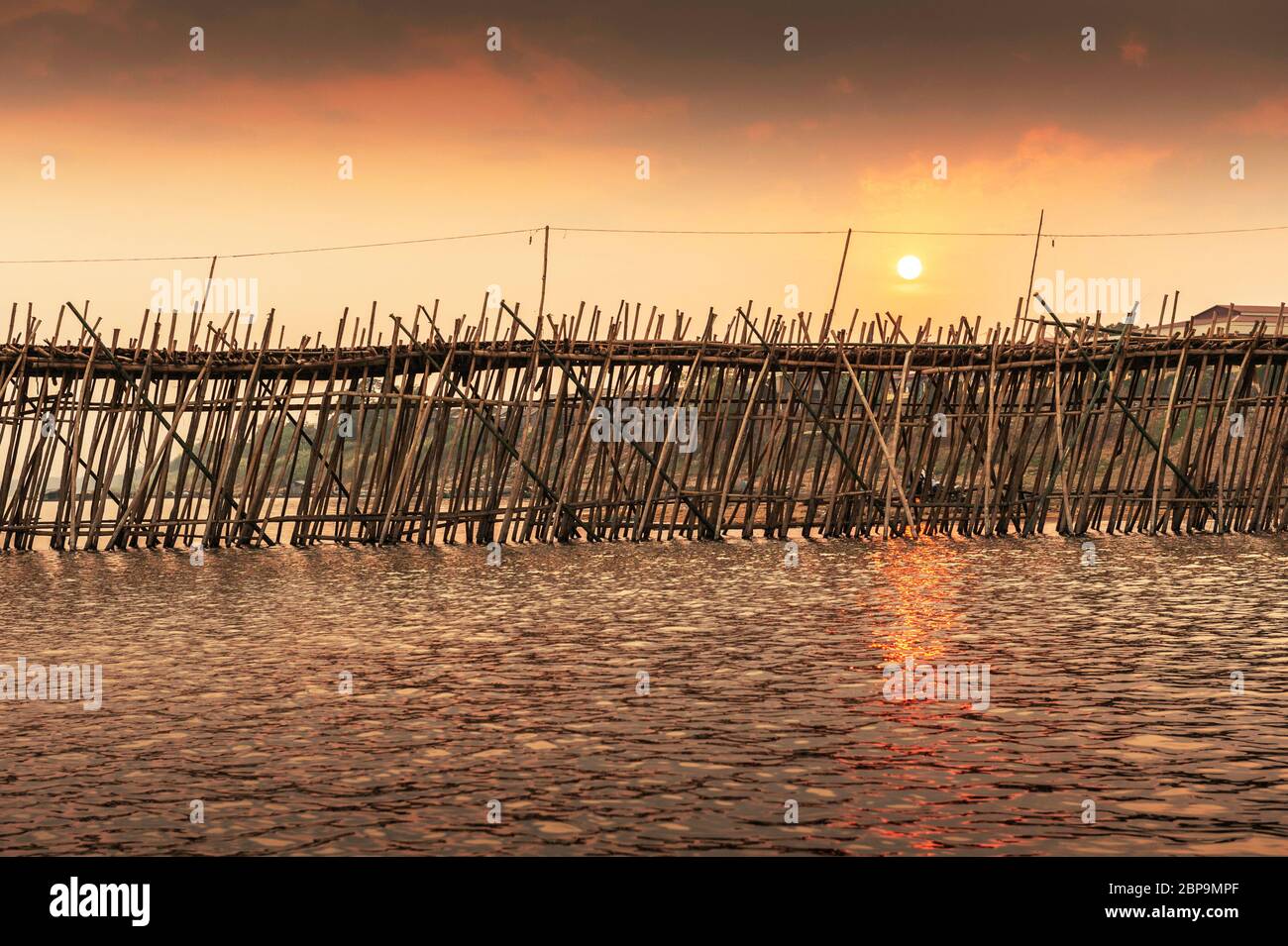 Bamboo bridge over the Mekong River at sunset. Ko Pen, Cambodia, Southeast Asia Stock Photo