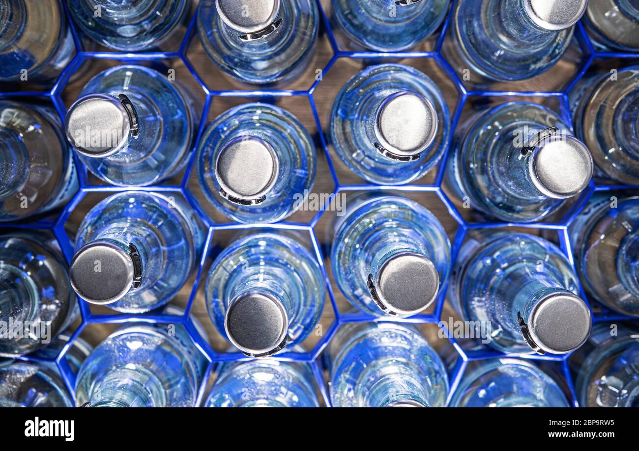 https://c8.alamy.com/comp/2BP9RW5/multiple-glass-water-bottles-with-pop-up-tops-organized-in-blue-wire-holders-2BP9RW5.jpg