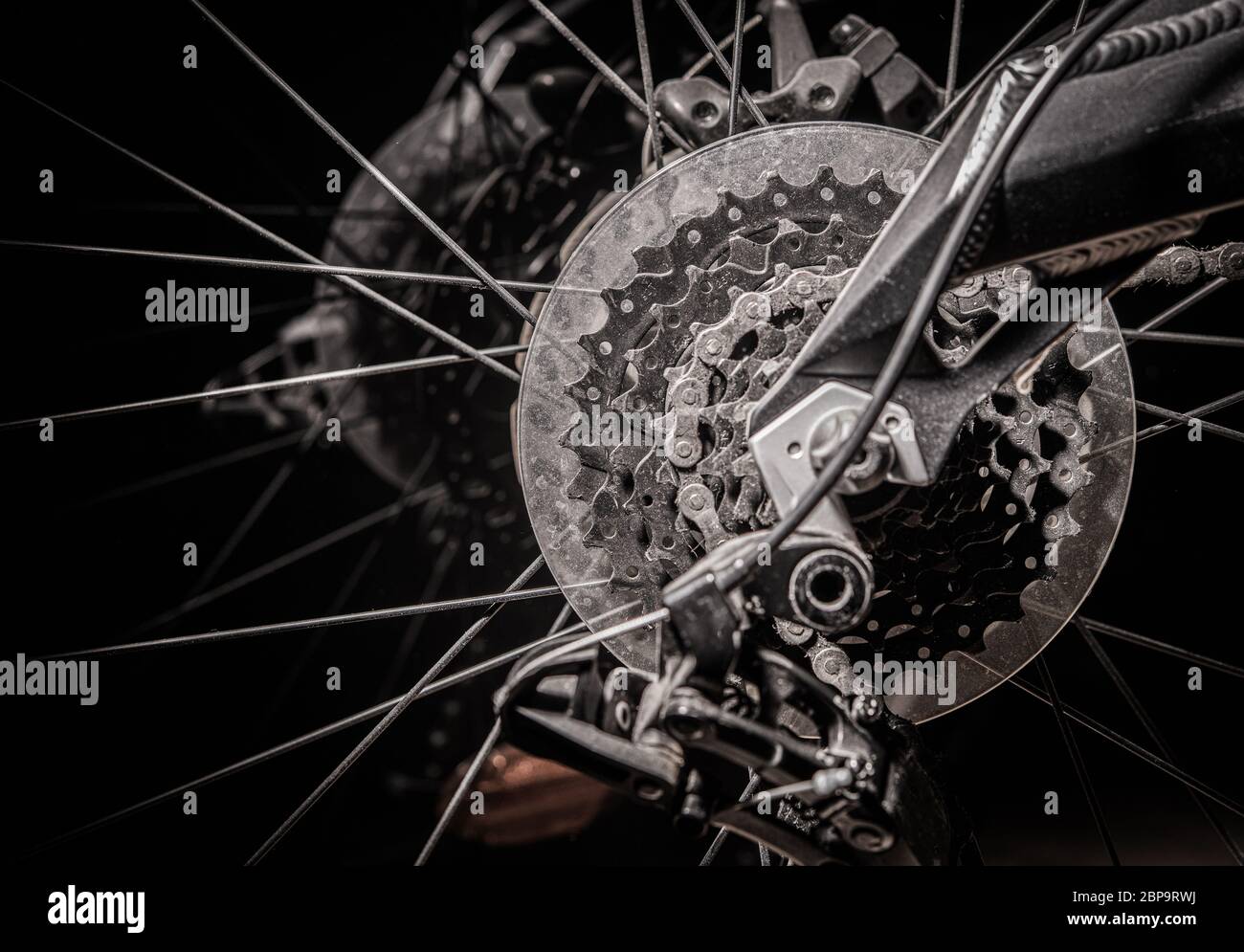 Close Up Of Bicycle Back Wheel With Metal Discs Spikes Chain And Gears. Stock Photo