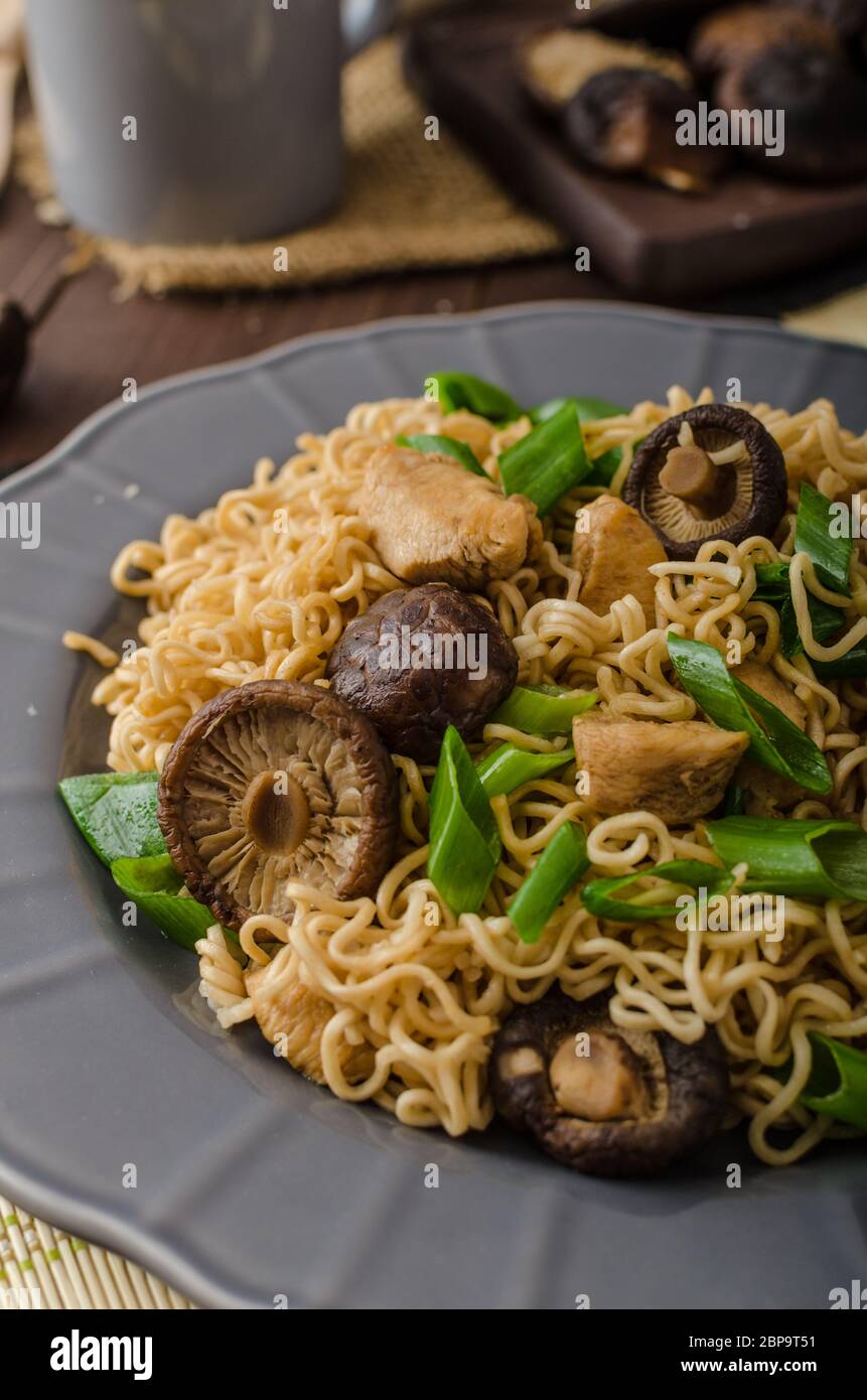 Chinese noodles with chicken and shitake, spring onion on top Stock