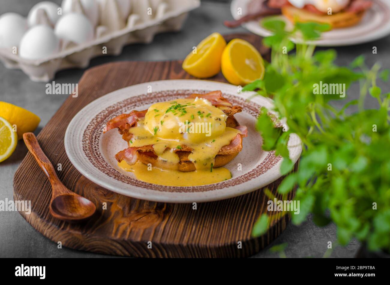 Eggs benedict with bacon, hollandaise sauce, delish food Stock Photo