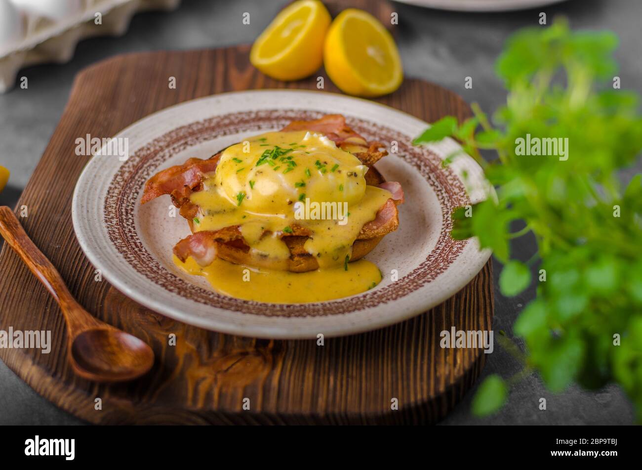 Eggs benedict with bacon, hollandaise sauce, delish food Stock Photo