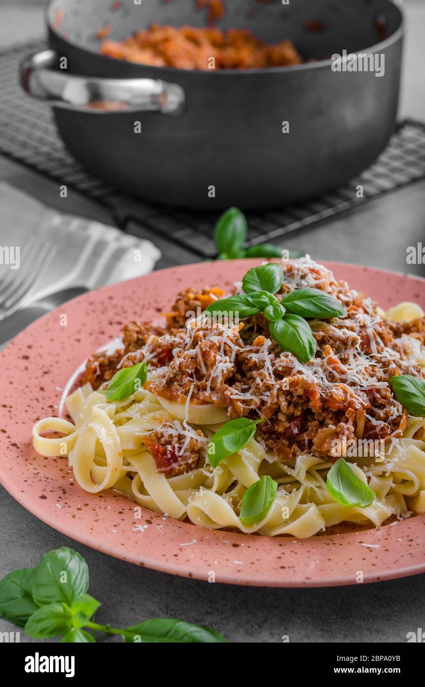 Pasta bolognese delish food, topped with fresh basil herb Stock Photo