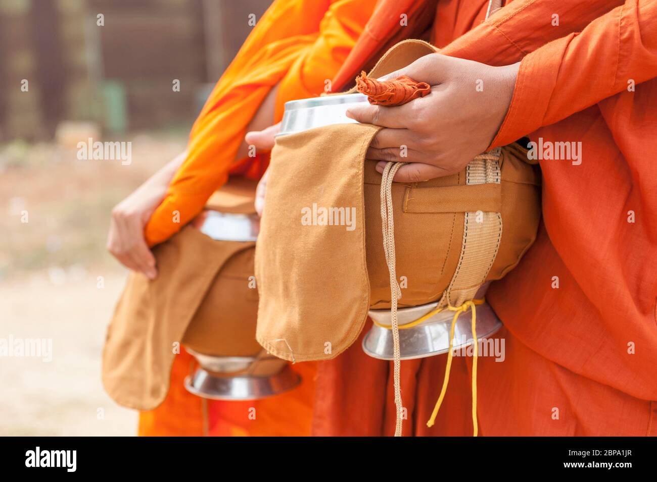 Almsgiving bowls held by buddist monks. Central Cambodia, Southeast Asia Stock Photo