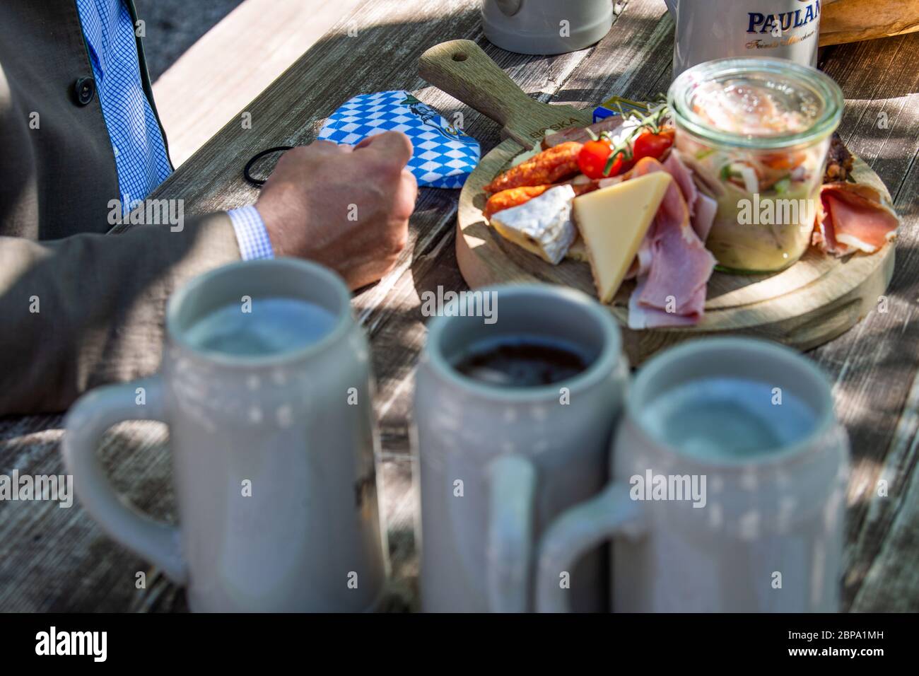 Munich, Germany. 18th May, 2020. A mouthguard is on the table next to snacks and beer mugs. In compliance with strict hygiene and distance rules, outdoor restaurants in Bavaria are allowed to open again until 8 p.m. after a corona break. Credit: Lino Mirgeler/dpa/Alamy Live News Stock Photo