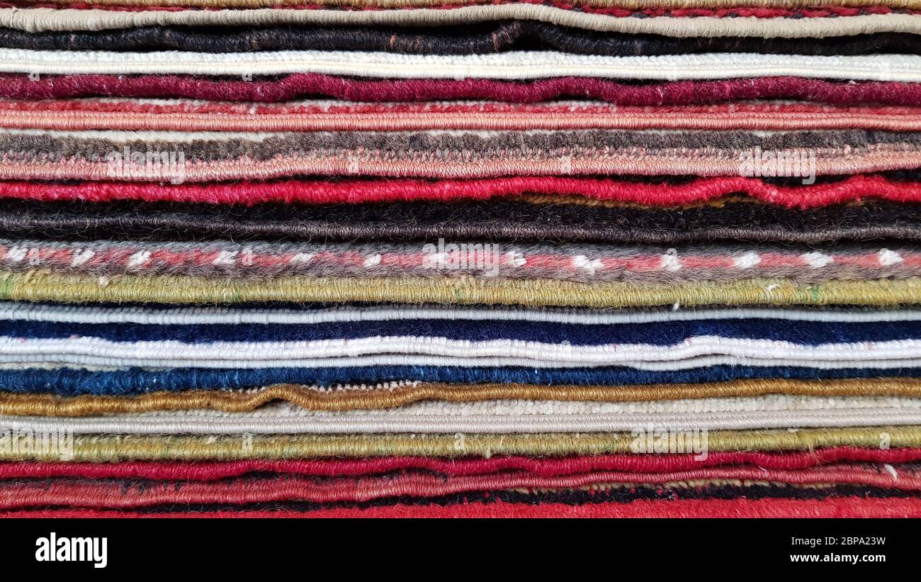 Stack of vintage Turkish carpets. Layers of colorful carpets. Woven  texture. Edges of ethnic rugs. Traditional Asian floor mats. Turkish bazaar  backdr Stock Photo - Alamy