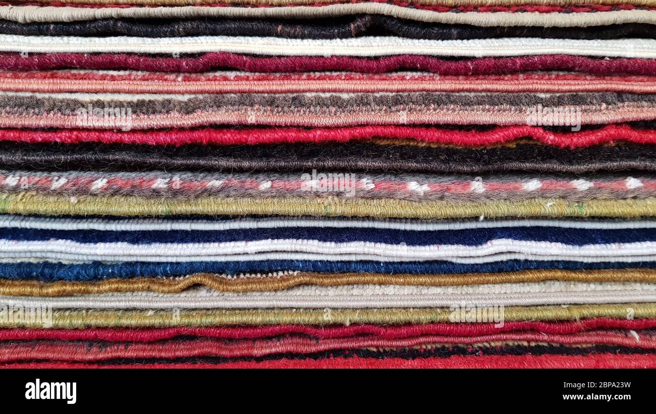 Stack of vintage Turkish carpets. Layers of colorful carpets. Woven