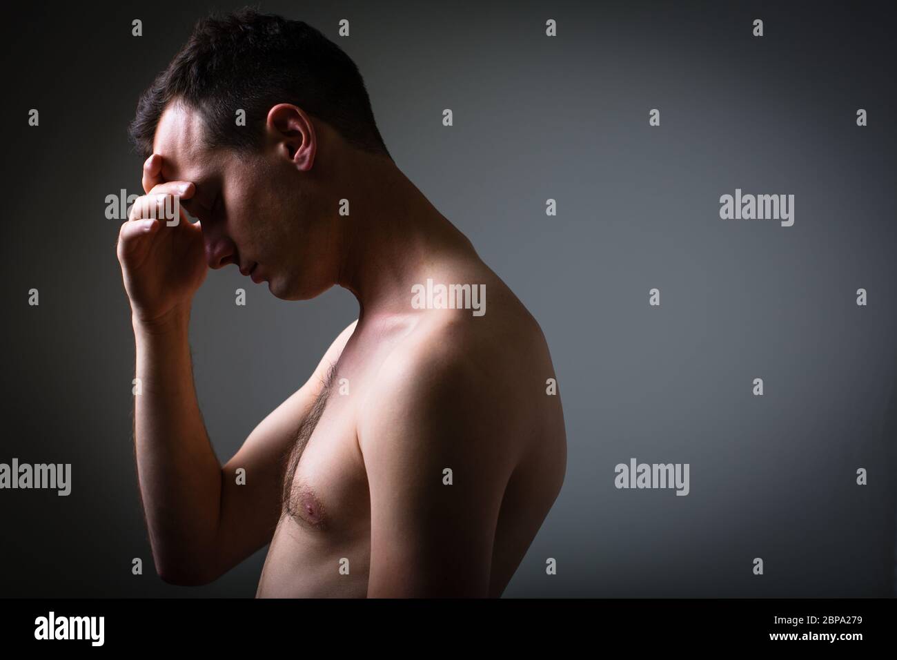 Depressed young man going through a rough patch in his life - suffering from mental exhaustion/anxiety/burnout/depression (color toned image) Stock Photo