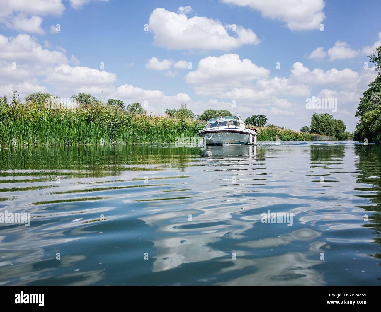 A river boat on the Upper River Thames near the Cotswolds in Oxfordshire Stock Photo