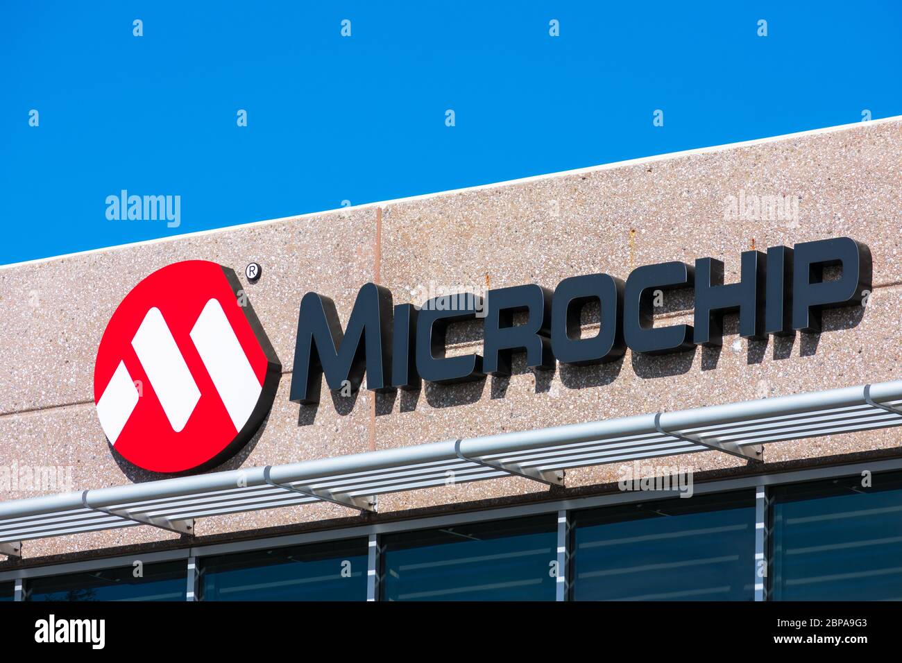 Microchip sign and logo. Microchip Technology Inc. manufactures microcontrollers, mixed-signal, analog and Flash-IP integrated circuits - San Jose, Ca Stock Photo
