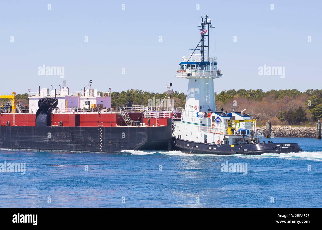 A barge and Tug passing through the Cape Cod Canal in Massachusetts, USA Stock Photo