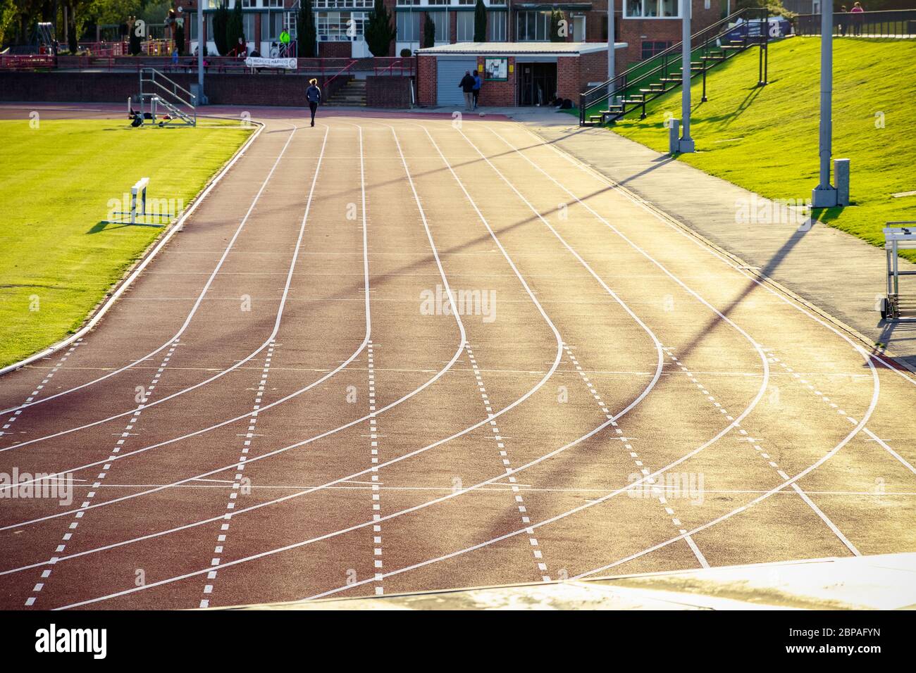 Parliament Hill Fields Athletics Track in London, all-weather running track backlit by sunlight Stock Photo