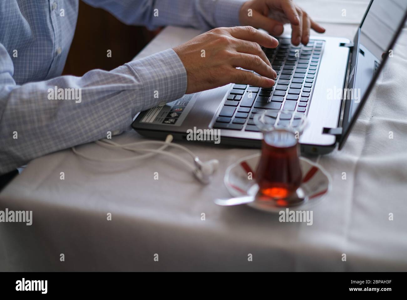 Middle-aged man is working with on laptop at home in quarantina days. Stock Photo