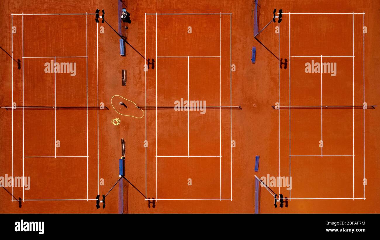 Grugliasco, Italy - 18 May, 2020: (EDITORS NOTE: Image was created with a drone.) Aerial view shows three empty clay tennis courts. The lockdown due to the COVID-19 coronavirus emergency banned all sports activities. Credit: Nicolò Campo/Alamy Live News Stock Photo