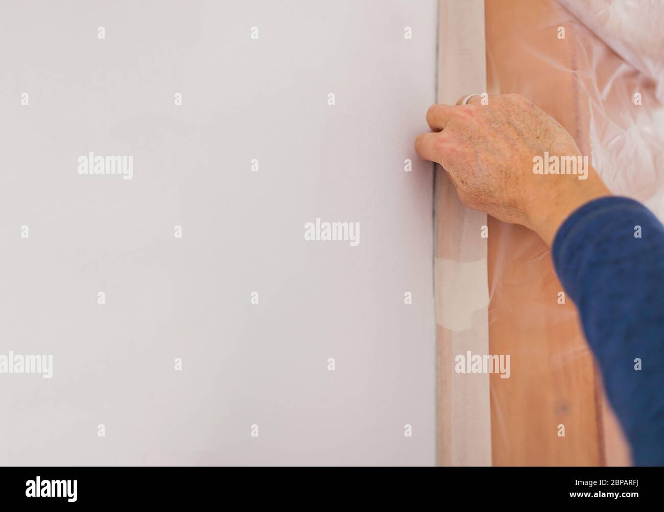 Human hand sticks with crepe beam window frames paint preparation