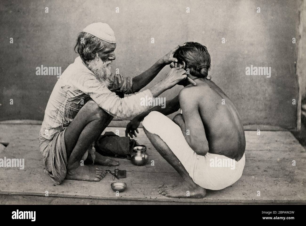 Indian barber shaving man with a razor Stock Photo