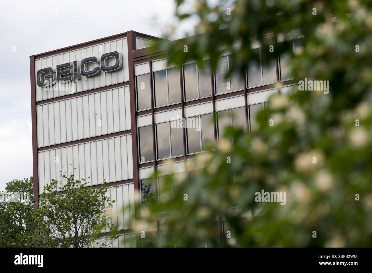 A logo sign outside of the headquarters of The Government Employees Insurance Company (GEICO) in Chevy Chase, Maryland on May 9, 2020. Stock Photo