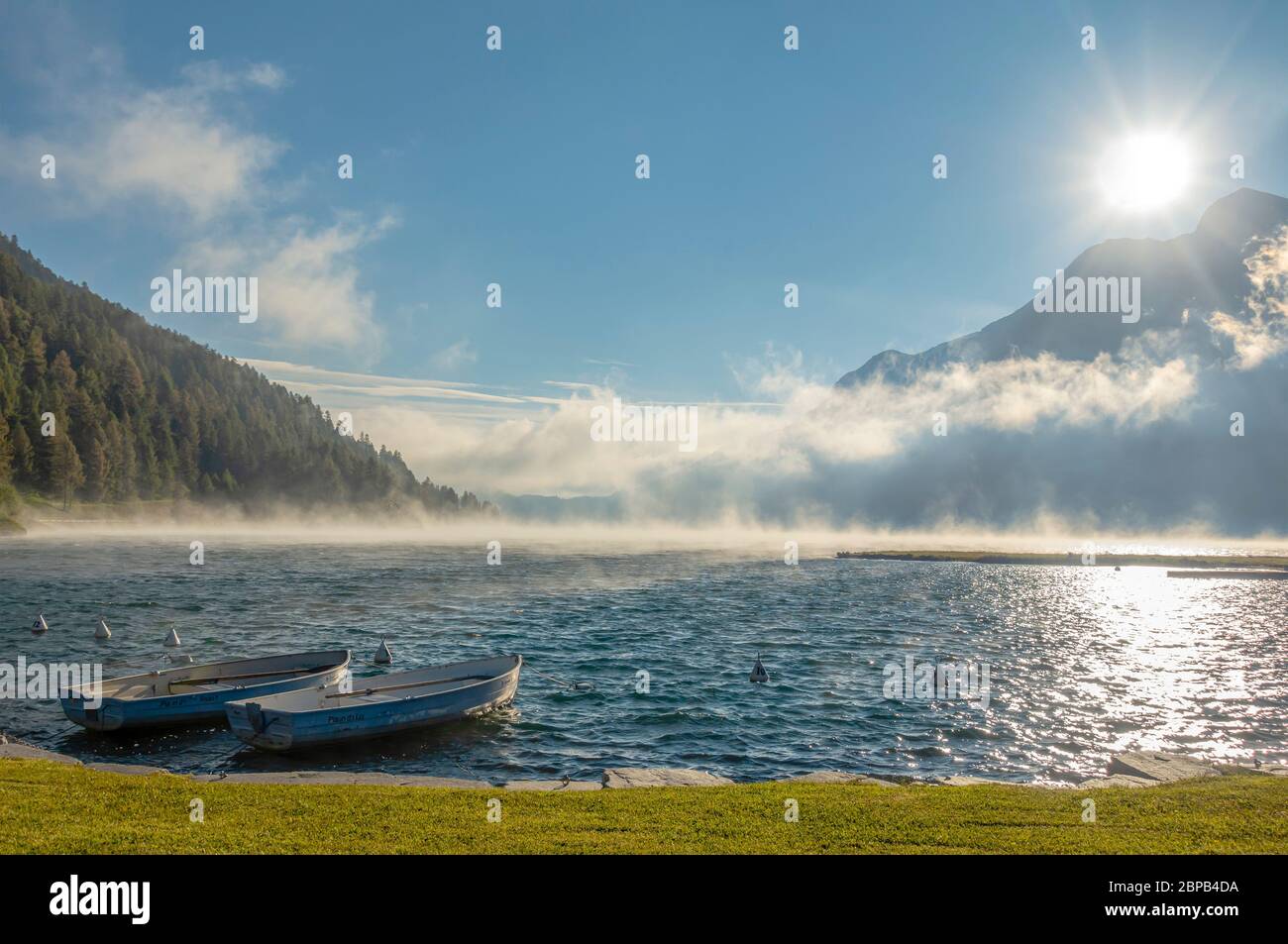 Rowing boats on a spring morning at Lake Silverplana near Sils Maria, Engadin, Grisons, Switzerland Stock Photo
