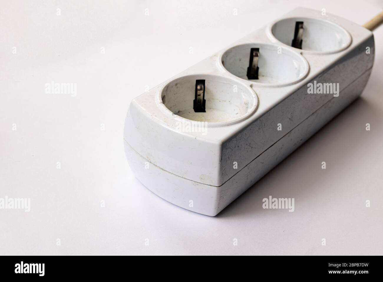 Old burnt extension cord on a white background Stock Photo Alamy