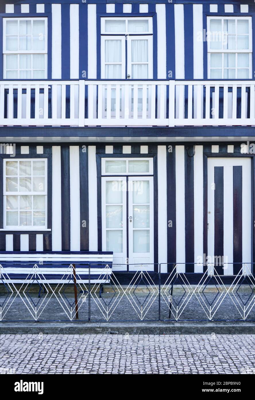 Striped facade and entrance door of a Charming typical Costa Nova house, with blue and white stripes. Stock Photo