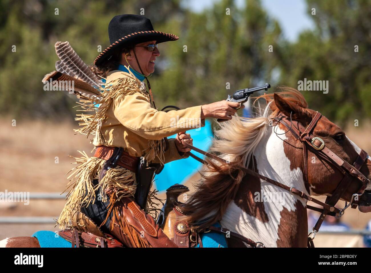 Cowgirl on horse, mounted shooting competition, End of Trail Wild West