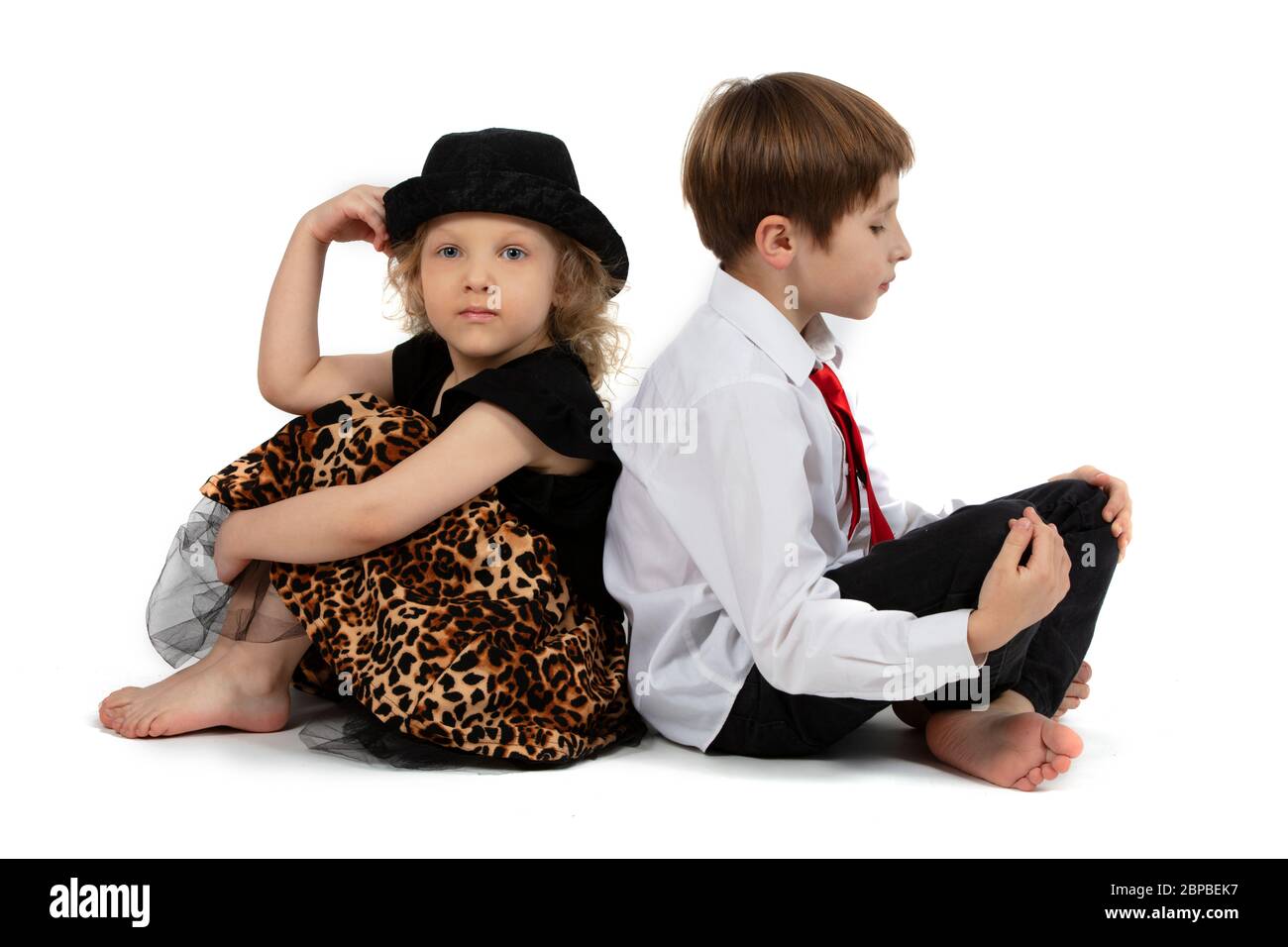 Beautiful children. Little girl and boy with their backs to each other. Funny children couple. Brother and sister. Valentines day and children Stock Photo
