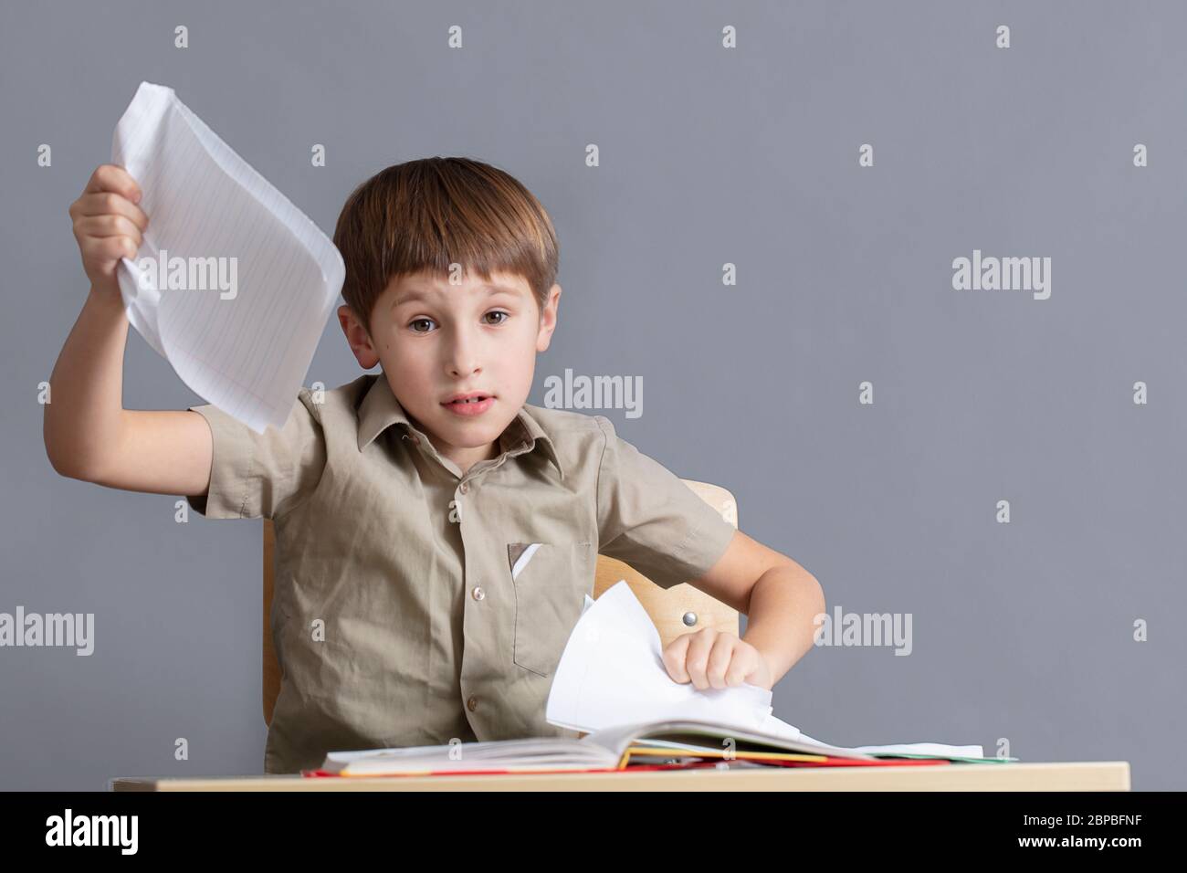 child ripping homework