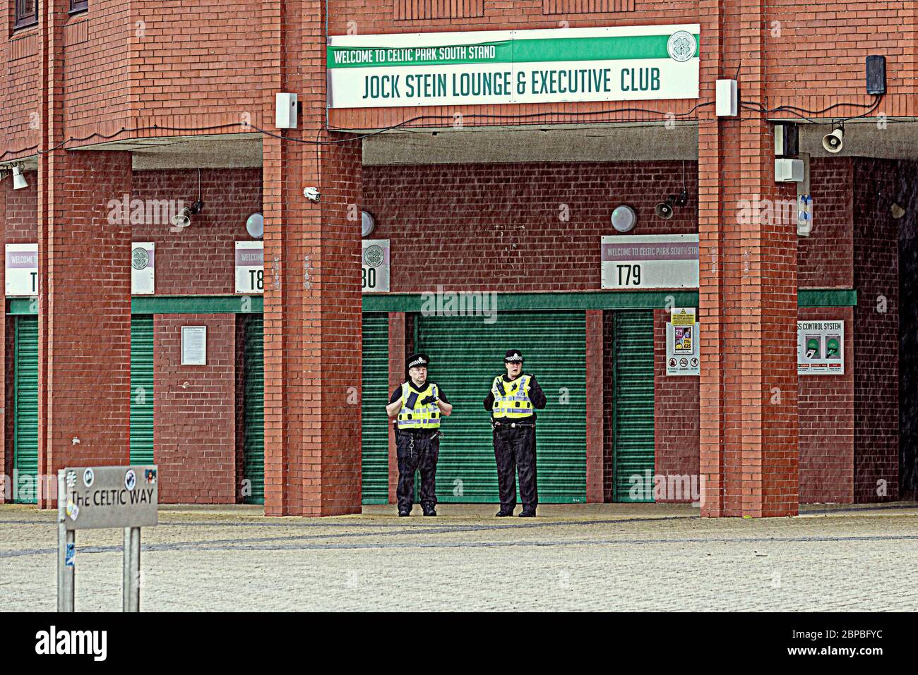 Glasgow, Scotland, UK 18th May, 2020: Celtic were awarded the scottish title and both the police and club suggested fans should stay away from the stadium. Police were out in force to ensure social distancing and it rained as some fans posed for pictures at the venue. Gerard Ferry/ Alamy Live News Stock Photo