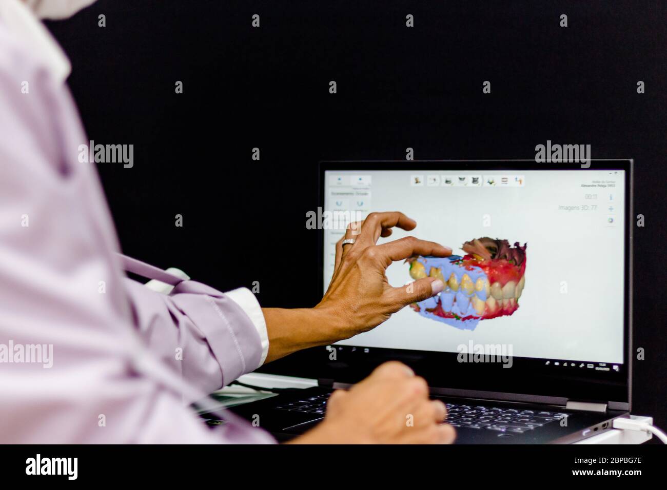 Dental technician hand explaining a 3d image of teeth Stock Photo