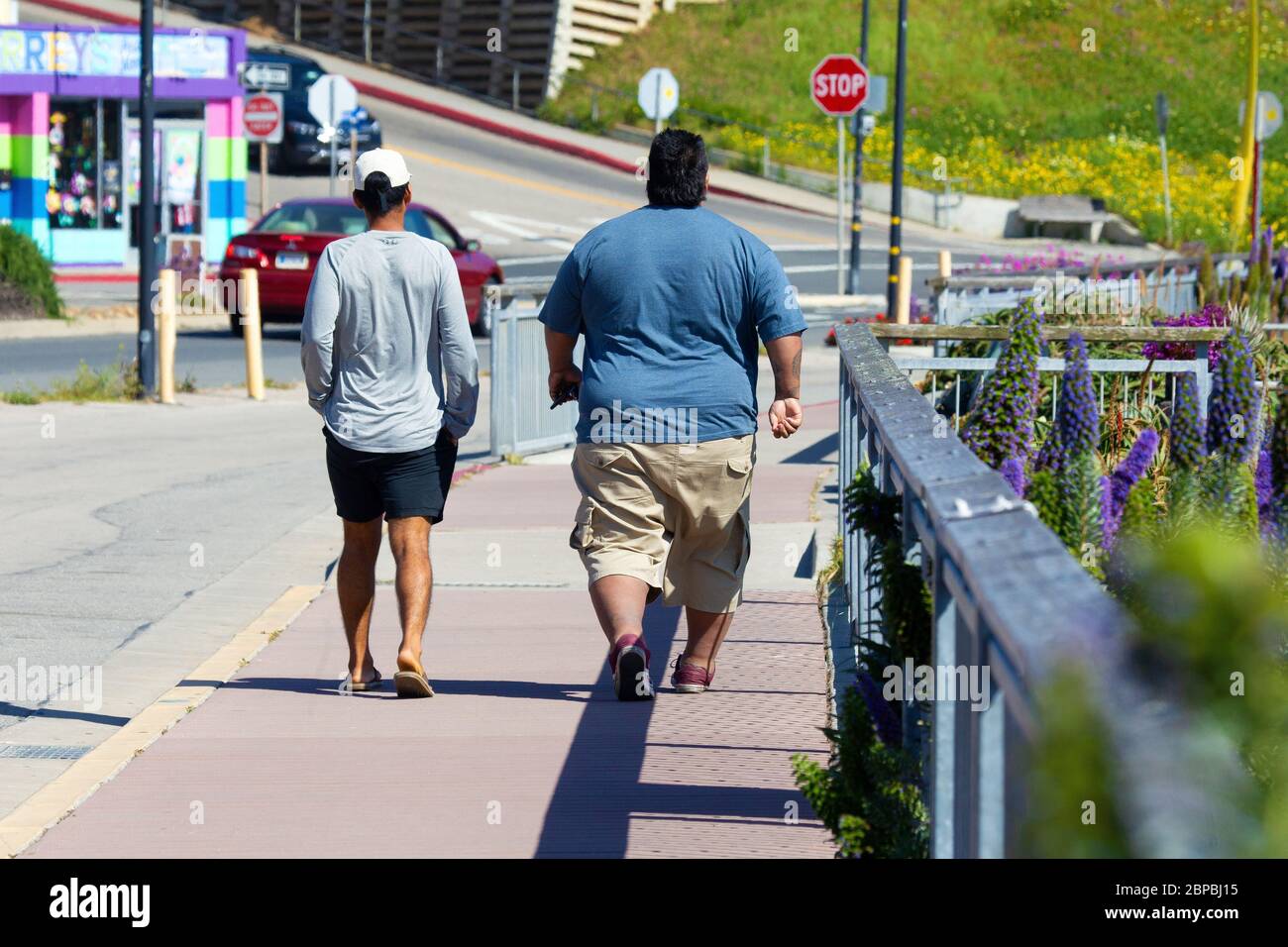 Obese man and Thin Man Walking Away Stock Photo