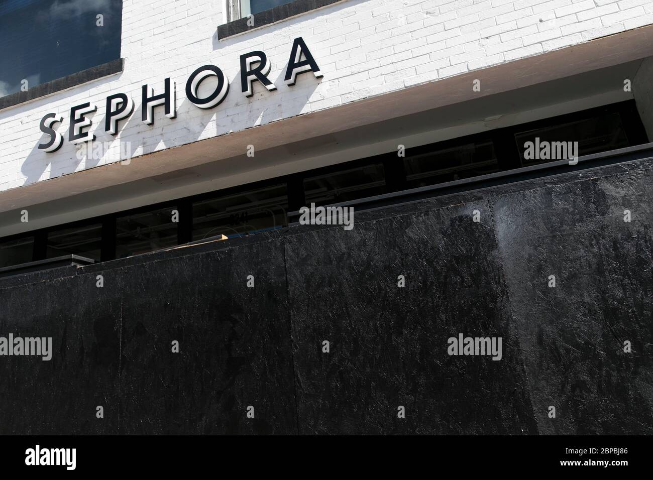 A logo sign outside of a boarded up and closed Sephora retail store location in Washington, D.C., on May 9, 2020. Stock Photo