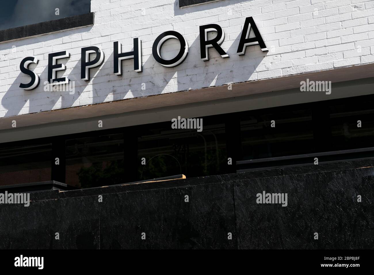 A logo sign outside of a boarded up and closed Sephora retail store location in Washington, D.C., on May 9, 2020. Stock Photo